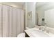 Bathroom featuring patterned shower curtain, a granite countertop, and a framed mirror at 12514 Goldenrod Ave, Bradenton, FL 34212