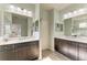 Dual sink bathroom vanity with dark wood cabinets, marble countertops, and a large mirror at 12514 Goldenrod Ave, Bradenton, FL 34212
