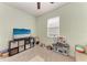 Bright bedroom with carpet, TV, and toy kitchen set, creating a fun space at 12514 Goldenrod Ave, Bradenton, FL 34212