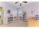 Lavender bedroom has carpet floors, fan and a single bed, creating a serene personal space at 12514 Goldenrod Ave, Bradenton, FL 34212