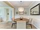 Elegant dining room featuring stylish lighting, wainscoting, and wood-look flooring at 12514 Goldenrod Ave, Bradenton, FL 34212
