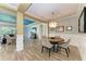 Open-concept dining area with modern chandelier and view to living spaces at 12514 Goldenrod Ave, Bradenton, FL 34212