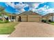 Charming single-story home featuring a brick driveway and manicured lawn at 12514 Goldenrod Ave, Bradenton, FL 34212