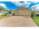 Well-maintained home with a two-car garage, brick driveway, and a neatly landscaped front yard at 12514 Goldenrod Ave, Bradenton, FL 34212
