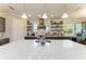 Modern kitchen featuring custom cabinets, a large island with a quartz countertop, and stainless steel appliances at 12514 Goldenrod Ave, Bradenton, FL 34212