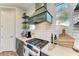 Gourmet kitchen with custom cabinets, open shelving, white subway tile backsplash, and stainless steel appliances at 12514 Goldenrod Ave, Bradenton, FL 34212