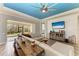 Bright living room with a sectional sofa, wood-look tile flooring, and sliding doors to the screened-in lanai at 12514 Goldenrod Ave, Bradenton, FL 34212