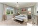 Serene main bedroom with a large window, neutral color palette, and elegant furnishings at 12514 Goldenrod Ave, Bradenton, FL 34212