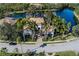 Aerial view of the property showing landscaping, pond, and proximity to water at 13315 Palmers Creek Ter, Lakewood Ranch, FL 34202