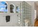 Unique bathroom with three arched windows and a glass block shower adding character at 13315 Palmers Creek Ter, Lakewood Ranch, FL 34202