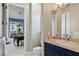 Half bath adjacent to the game room with blue vanity at 13315 Palmers Creek Ter, Lakewood Ranch, FL 34202
