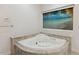 Modern corner soaking tub with beach view from the window in the bathroom at 13315 Palmers Creek Ter, Lakewood Ranch, FL 34202