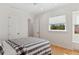 Bright bedroom with modern decor, including a gray bed frame, striped bedding, and hardwood floors at 13315 Palmers Creek Ter, Lakewood Ranch, FL 34202