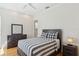 Bedroom with modern decor, including a gray bed frame, striped bedding, and white brick accent wall at 13315 Palmers Creek Ter, Lakewood Ranch, FL 34202