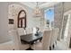 Formal dining room with a decorative wood table, chandelier, and arched window at 13315 Palmers Creek Ter, Lakewood Ranch, FL 34202