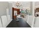 Elegant dining room showcasing a dark wood table and a sparkling chandelier at 13315 Palmers Creek Ter, Lakewood Ranch, FL 34202