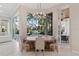 Dining area with chandelier and views of the outdoor pool area at 13315 Palmers Creek Ter, Lakewood Ranch, FL 34202