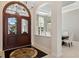 Elegant foyer featuring a decorative front door, beautiful tile flooring, and views into the dining area at 13315 Palmers Creek Ter, Lakewood Ranch, FL 34202