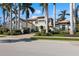 Beautiful two-story home with lush landscaping, a paver driveway, and mature palm trees surrounding the property at 13315 Palmers Creek Ter, Lakewood Ranch, FL 34202