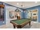 Open concept game room with pool table and custom lighting at 13315 Palmers Creek Ter, Lakewood Ranch, FL 34202