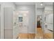 Hallway leading to a bright bathroom and walk-in closet with hardwood floors at 13315 Palmers Creek Ter, Lakewood Ranch, FL 34202
