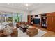 Comfortable living room with built-in shelving, plush seating, and sliding glass doors to the lanai at 13315 Palmers Creek Ter, Lakewood Ranch, FL 34202