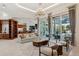 Open-concept living room with a view of the kitchen, pool, and stylish furniture at 13315 Palmers Creek Ter, Lakewood Ranch, FL 34202