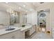 Bathroom with a large mirror, chandelier, double sinks, and hardwood floors at 13315 Palmers Creek Ter, Lakewood Ranch, FL 34202