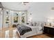 Bright and airy main bedroom featuring three arched windows, wood floors and minimalist design at 13315 Palmers Creek Ter, Lakewood Ranch, FL 34202