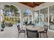 View of outdoor seating area with pool, spa, and palms in the background at 13315 Palmers Creek Ter, Lakewood Ranch, FL 34202