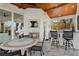 Covered outdoor kitchen and dining space with a stone fireplace and bar seating at 13315 Palmers Creek Ter, Lakewood Ranch, FL 34202