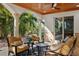 Relaxing covered patio with comfortable seating, decorative columns, and a view of the lush greenery at 13315 Palmers Creek Ter, Lakewood Ranch, FL 34202