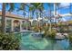 Covered pool featuring a fountain, landscaping, outdoor lounge area, and classical arches at 13315 Palmers Creek Ter, Lakewood Ranch, FL 34202