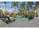 Beautiful enclosed pool area with tropical plants, comfortable lounge chairs, and lots of space at 13315 Palmers Creek Ter, Lakewood Ranch, FL 34202