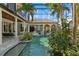 View of the covered pool with attached spa, plants, and outdoor lounge areas at 13315 Palmers Creek Ter, Lakewood Ranch, FL 34202