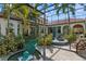 View of screened-in pool with water features, landscaping, and outdoor seating at 13315 Palmers Creek Ter, Lakewood Ranch, FL 34202