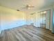 Spacious bedroom with wood flooring, mirrored closet doors, and white trim at 1423 56Th W St # 1423, Bradenton, FL 34209