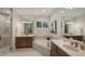 Bright bathroom with double sinks, a soaking tub, and a glass-enclosed shower at 14510 Leopard Creek Pl, Lakewood Ranch, FL 34202