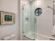Bathroom featuring a glass-enclosed shower with a unique round window at 14510 Leopard Creek Pl, Lakewood Ranch, FL 34202