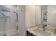 Bright bathroom featuring a shower-tub combo, white tile, and vanity with quartz countertop at 14510 Leopard Creek Pl, Lakewood Ranch, FL 34202