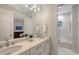 Bathroom featuring double sinks, modern finishes, and an adjacent shower room at 14510 Leopard Creek Pl, Lakewood Ranch, FL 34202