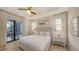 Well-lit bedroom with access to outdoor patio, ensuite bathroom, and neutral decor at 14510 Leopard Creek Pl, Lakewood Ranch, FL 34202