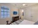 Bedroom featuring a wall-mounted TV and shuttered windows at 14510 Leopard Creek Pl, Lakewood Ranch, FL 34202