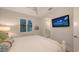 Bedroom view, showcasing the ensuite bathroom and a wall-mounted television at 14510 Leopard Creek Pl, Lakewood Ranch, FL 34202