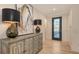 Entryway with decorative console table, hardwood floors, and glass paneled front door at 14510 Leopard Creek Pl, Lakewood Ranch, FL 34202