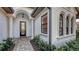 Charming entryway with decorative columns, and a stone walkway, surrounded by lush greenery at 14510 Leopard Creek Pl, Lakewood Ranch, FL 34202