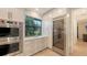Modern kitchen with stainless steel appliances, custom cabinetry, and a built-in wine fridge at 14510 Leopard Creek Pl, Lakewood Ranch, FL 34202