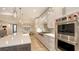 Well-equipped kitchen with stainless steel appliances and a large island with seating at 14510 Leopard Creek Pl, Lakewood Ranch, FL 34202
