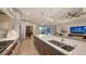 Gourmet kitchen with a center island, stainless steel appliances, and view of the cozy living area at 14510 Leopard Creek Pl, Lakewood Ranch, FL 34202