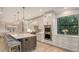 Bright kitchen with a long island, stainless appliances, and stylish pendant lighting at 14510 Leopard Creek Pl, Lakewood Ranch, FL 34202